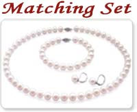 white colored pearl necklace, pearl bracelet, and a pair of pearl earrings