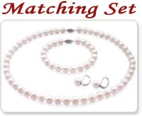 white colored pearl necklace, pearl bracelet, and a pair of pearl earrings