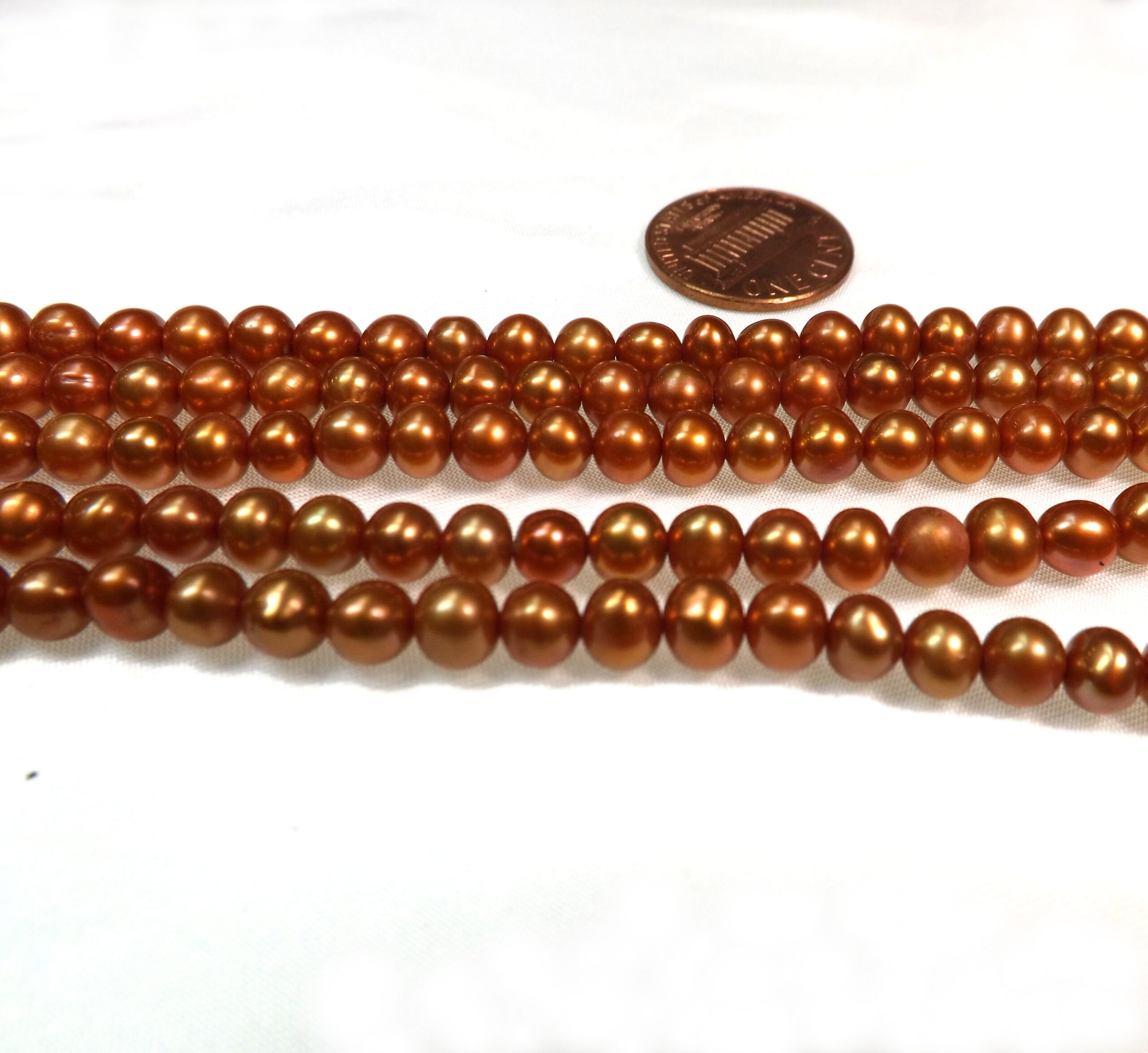 5-6mm Orange Colored Nice Quality Potato Pearls on a Temporarily Strung Strand