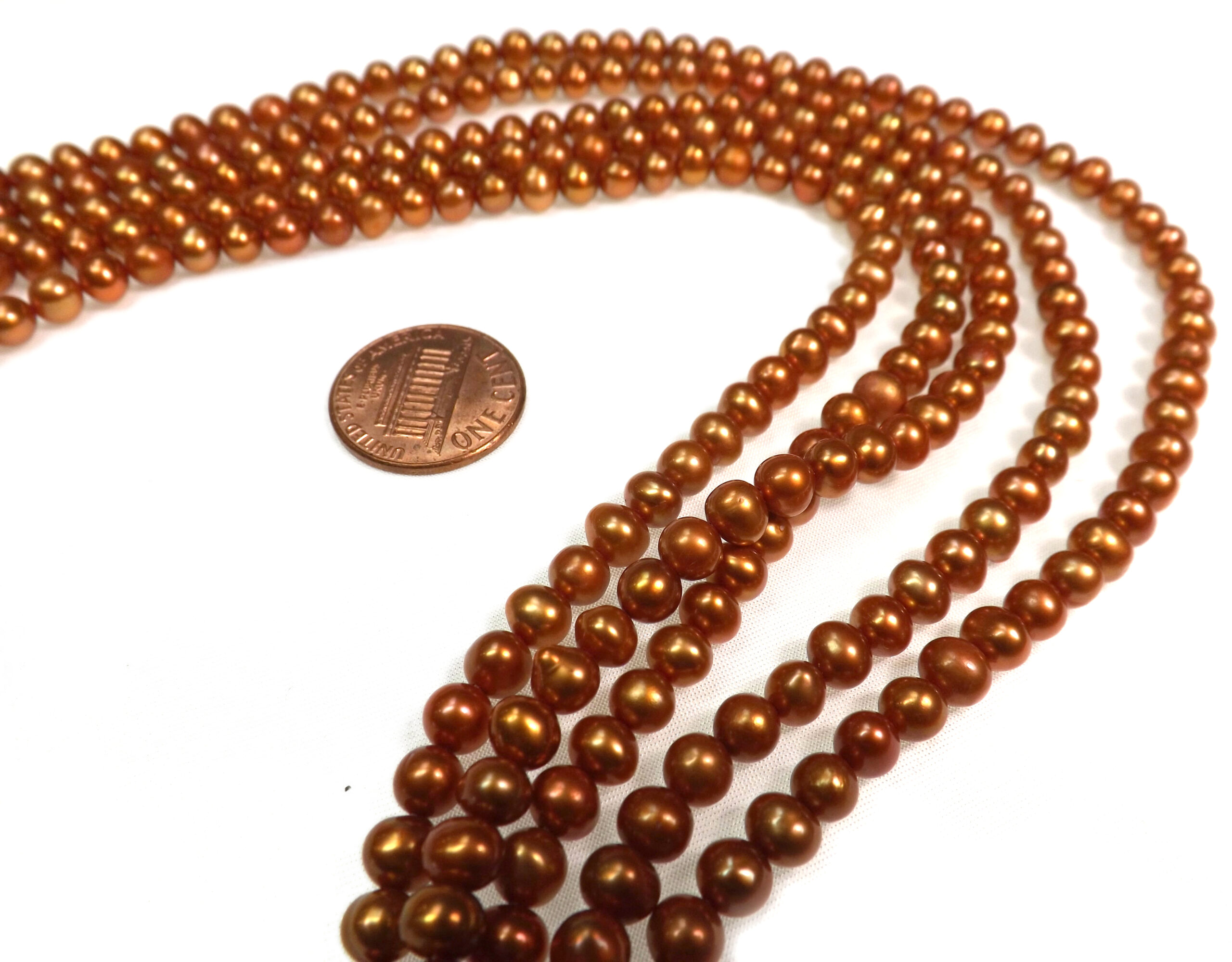 5-6mm Orange Colored Nice Quality Potato Pearls on a Temporarily Strung Strand