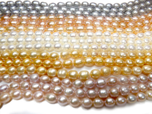 Grey, pink, white, champagne and mauve colored 8-9mm rice or oval shaped pearls on strands