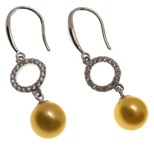 a pair of dangling gold pearl earrings with a circle on top with diamonds around