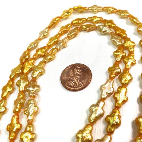 Gold colored cross shaped pearls on loose strands