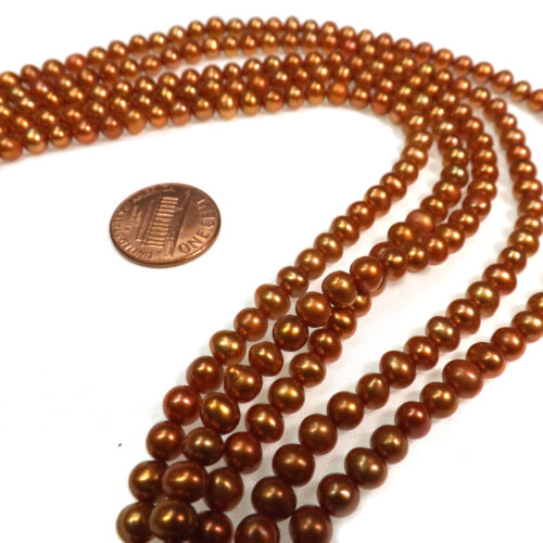 5-6mm Orange Colored Nice Quality Potato Pearls on a Temporarily Strung Strand